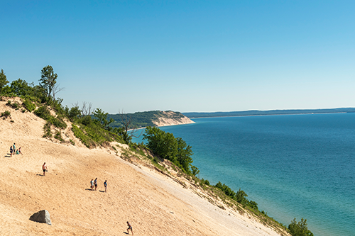 People climbing the dunes